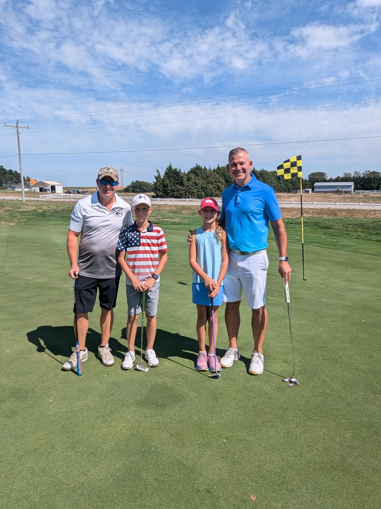 Foursome of golfers on the green